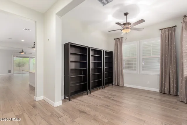 a view of an empty room with a window and closet area