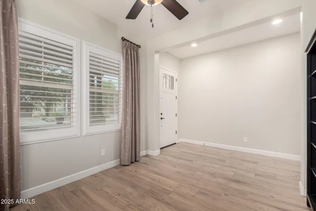 wooden floor in an empty room with a window