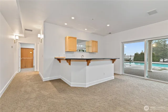 a view of a kitchen with a sink and cabinets