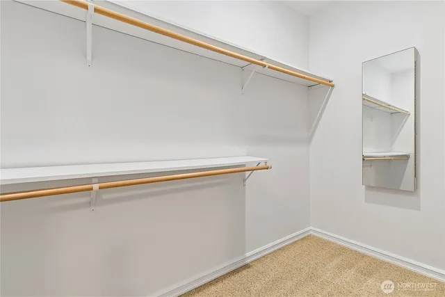 a view of a closet with wooden floor