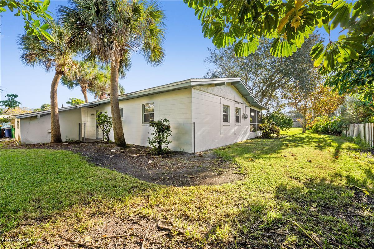 650 Java Road Cocoa Beach, FL 32931 - Photo 17 of 39 a view of a yard with plants and large tree