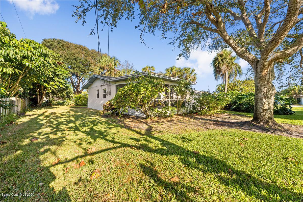 650 Java Road Cocoa Beach, FL 32931 - Photo 18 of 39 a view of a yard with plants and large trees