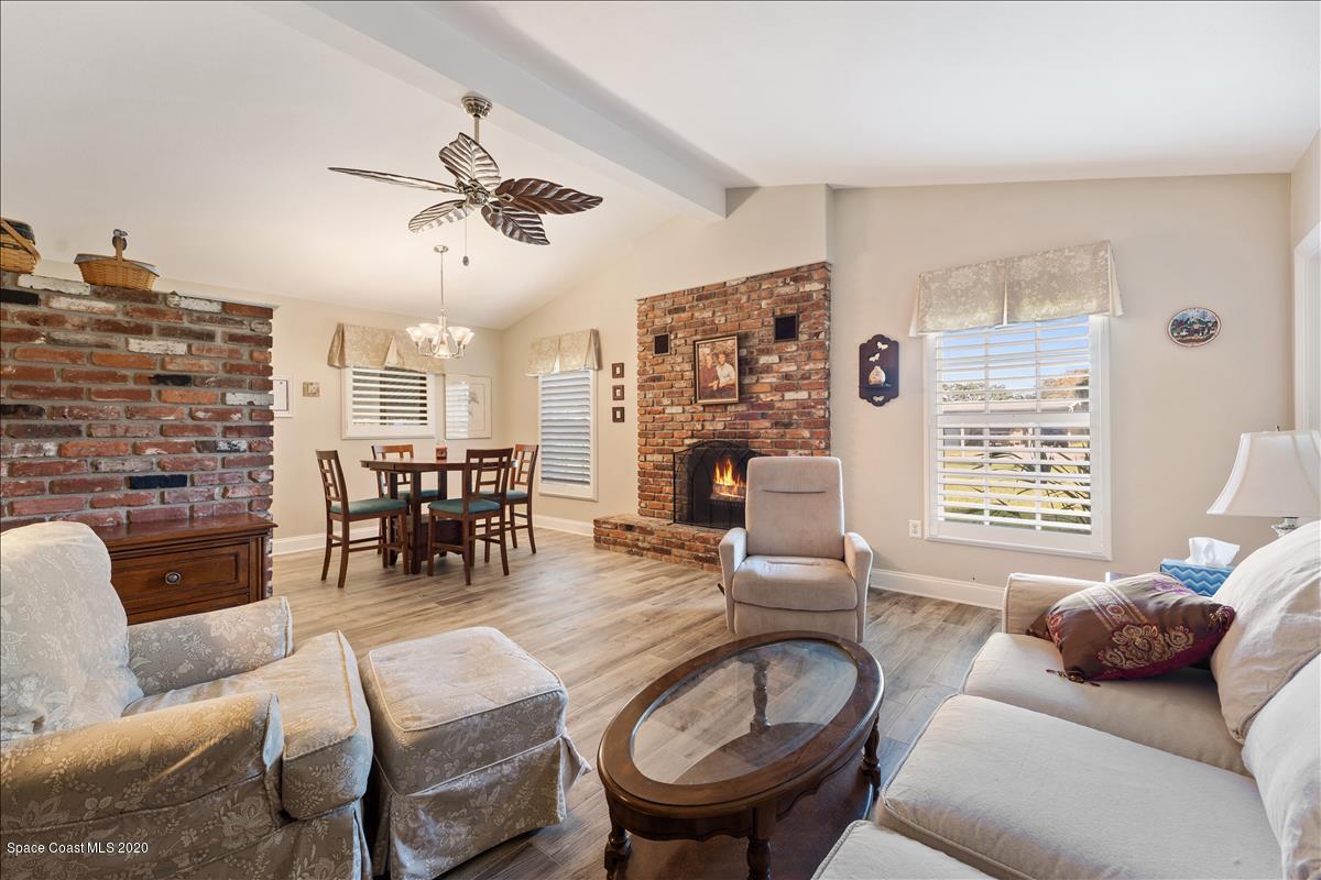 650 Java Road Cocoa Beach, FL 32931 - Photo 20 of 39 a living room with furniture and a fireplace