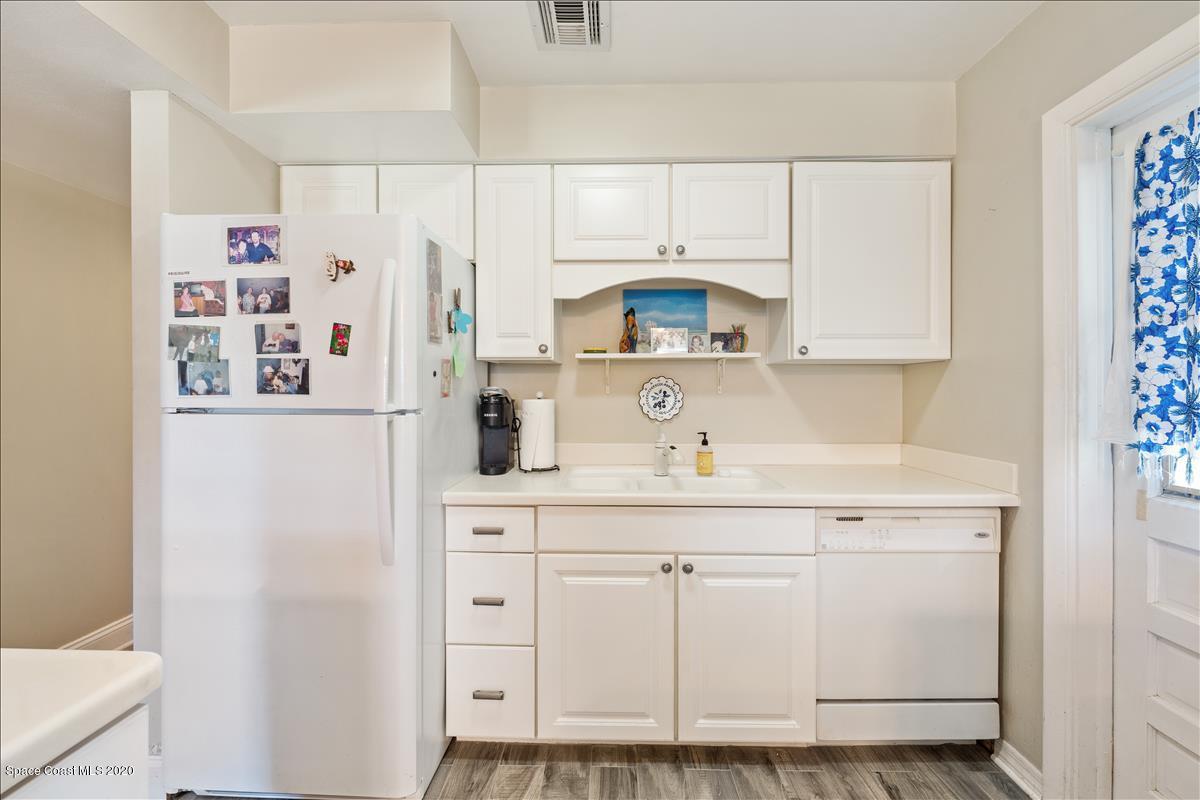 650 Java Road Cocoa Beach, FL 32931 - Photo 26 of 39 a kitchen with cabinets and a refrigerator