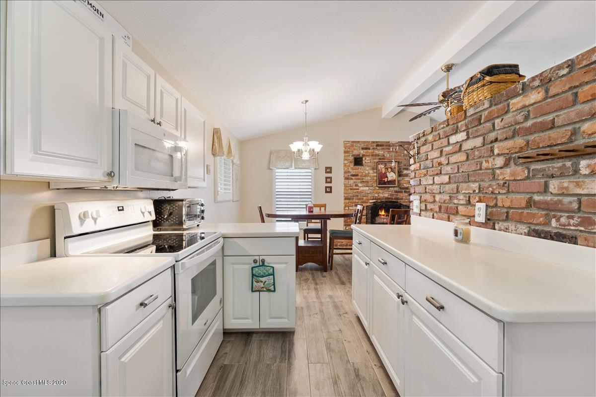 650 Java Road Cocoa Beach, FL 32931 - Photo 27 of 39 a kitchen with cabinets and white appliances