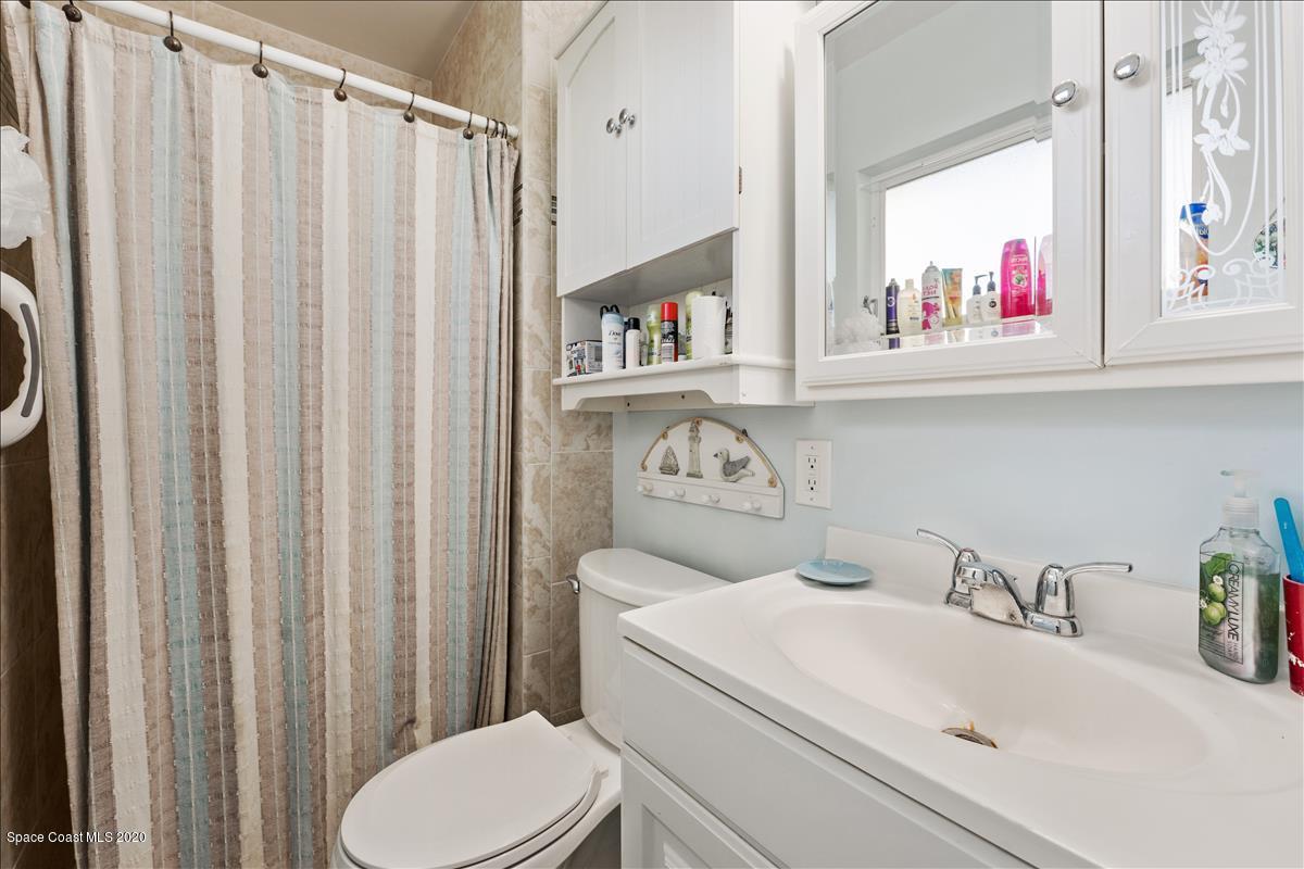 650 Java Road Cocoa Beach, FL 32931 - Photo 30 of 39 a bathroom with a sink and a toilet next to a window