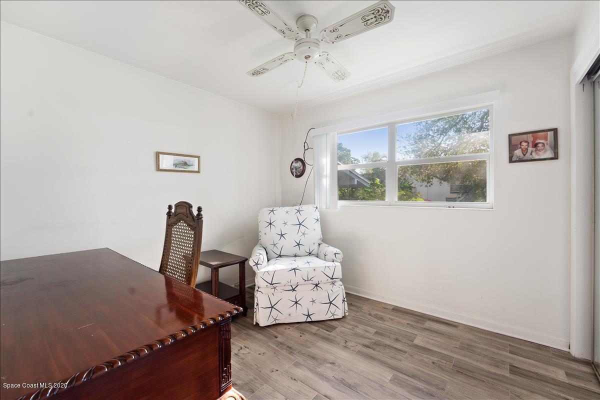 650 Java Road Cocoa Beach, FL 32931 - Photo 33 of 39 a bedroom with a bed and wooden floor