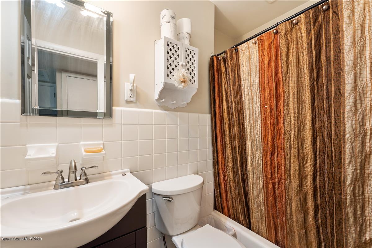 650 Java Road Cocoa Beach, FL 32931 - Photo 37 of 39 a bathroom with a sink a toilet and mirror