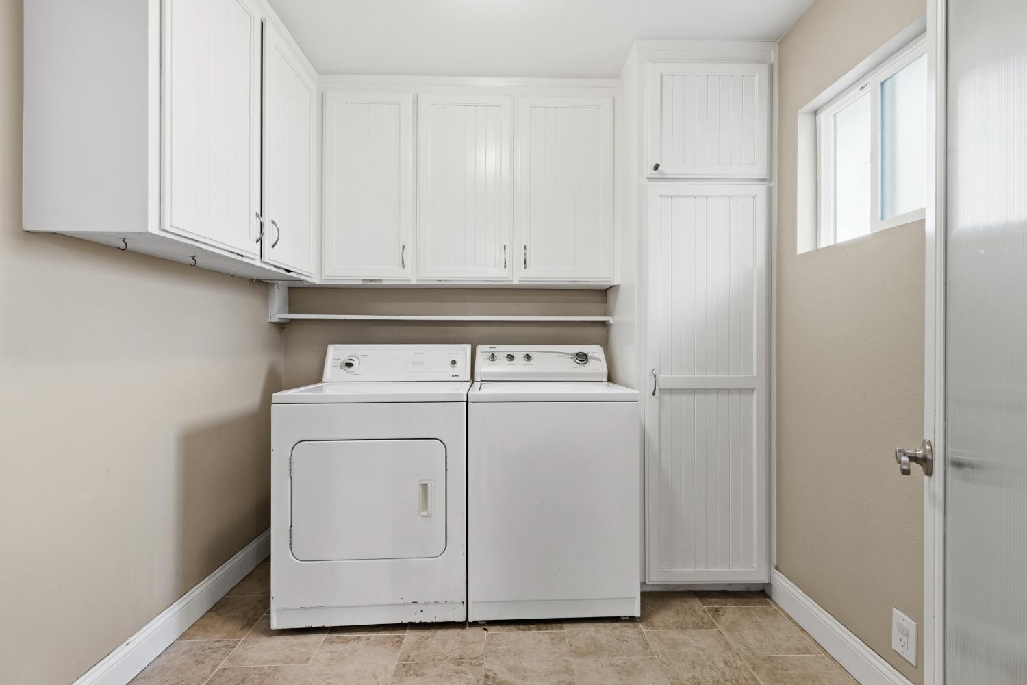550 Bell Street Turlock, CA 95380 - Photo 13 of 36 a view of washer and dryer with white cabinet