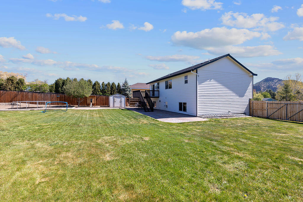 2979 Northeast Sugar Pine Road Prineville, OR 97754 - Photo 22 of 31 a backyard of a house with lots of green space and garden