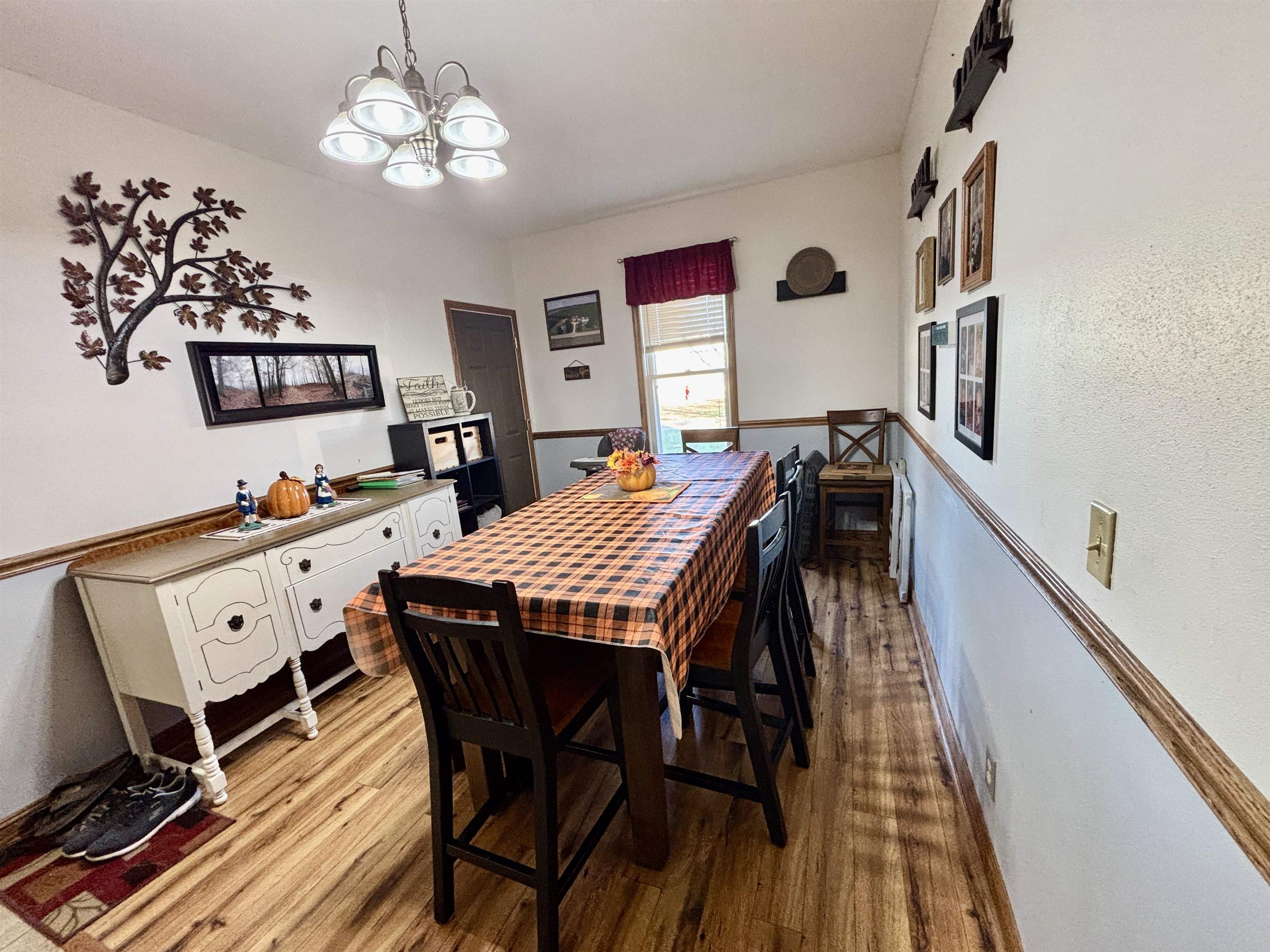 12916 Grange Hall Road Capron, IL 61012 - Photo 12 of 48 a view of a dining room with furniture wooden floor and chandelier
