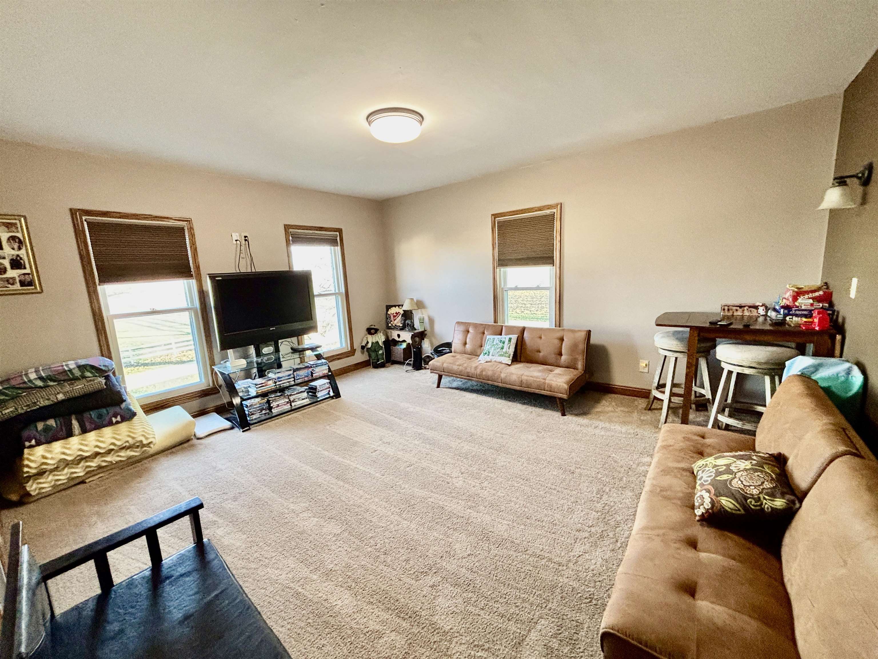 12916 Grange Hall Road Capron, IL 61012 - Photo 25 of 48 a living room with furniture and a flat screen tv