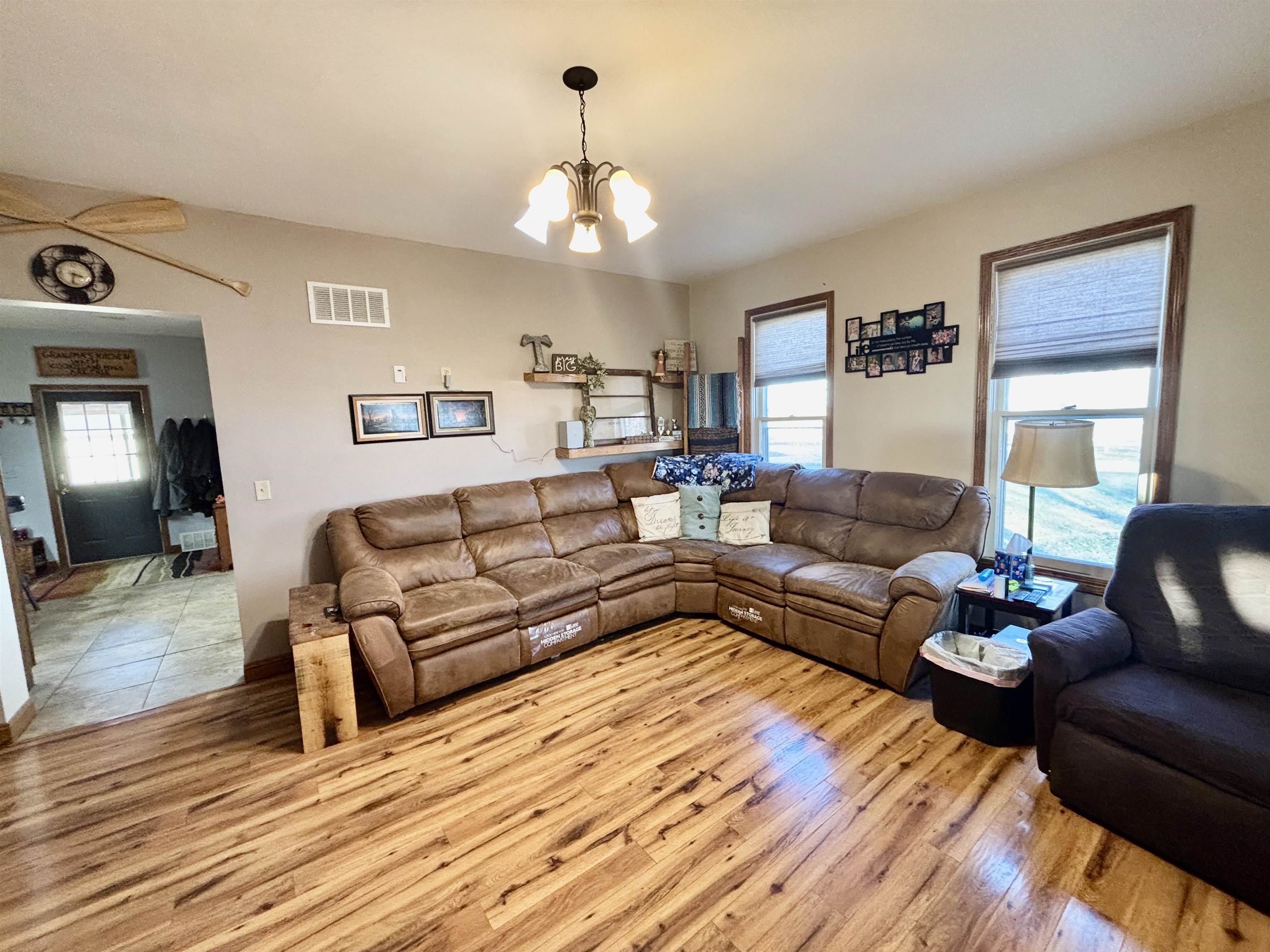 12916 Grange Hall Road Capron, IL 61012 - Photo 5 of 48 a living room with furniture or couch and a chandelier