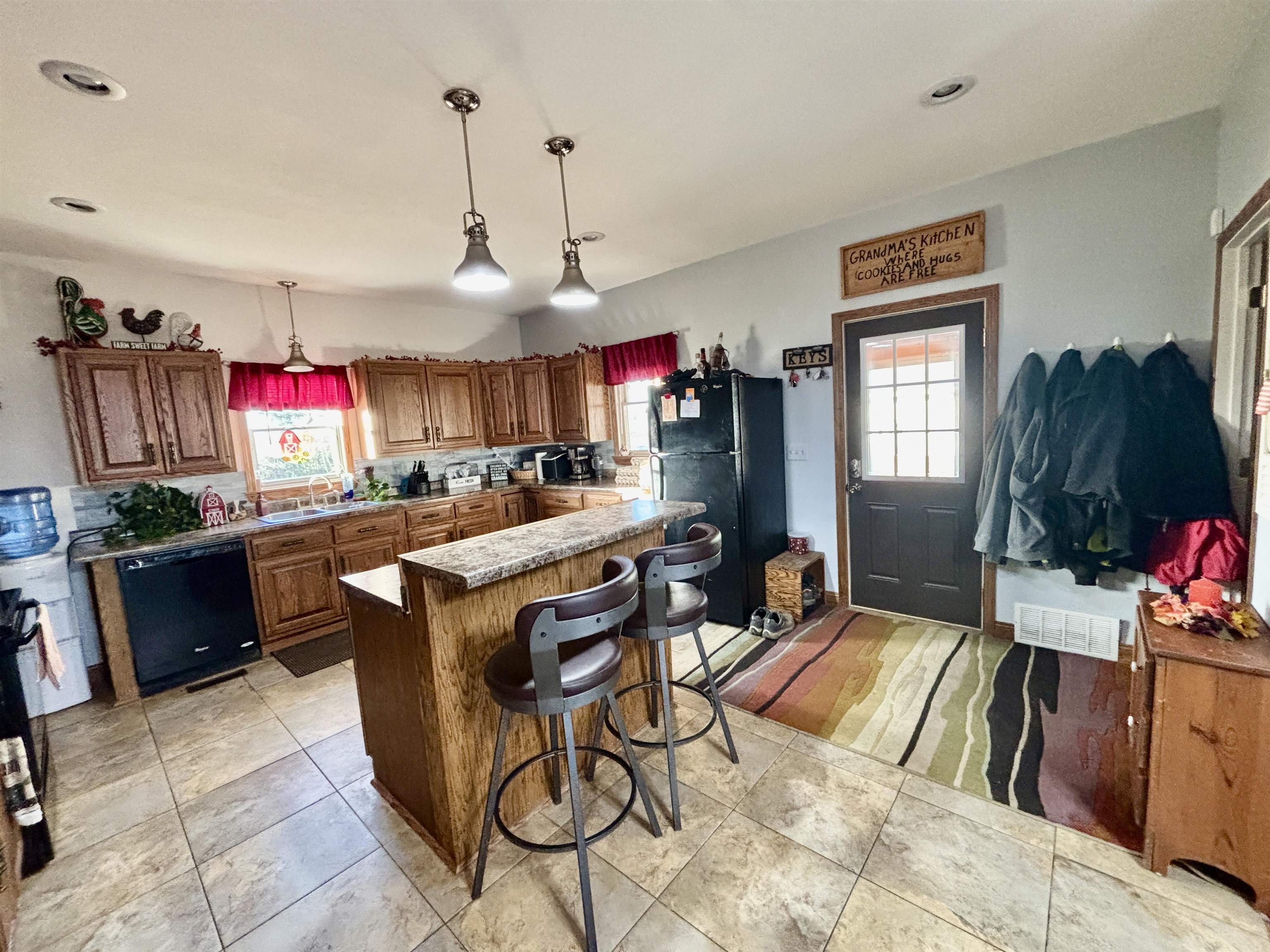 12916 Grange Hall Road Capron, IL 61012 - Photo 8 of 48 a open kitchen with stainless steel appliances granite countertop a sink dishwasher a dining table and chairs with the kitchen view