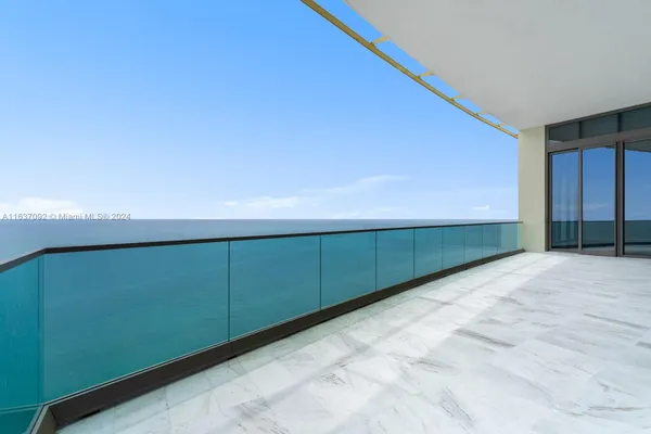 a bathroom with a glass shower door and a window