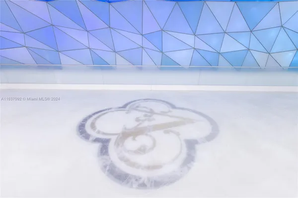 a room with pool table and windows