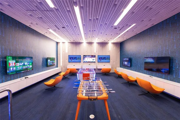 a media room with lots of chairs and a projector screen