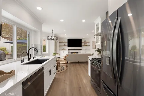 a kitchen with stainless steel appliances a sink stove and refrigerator