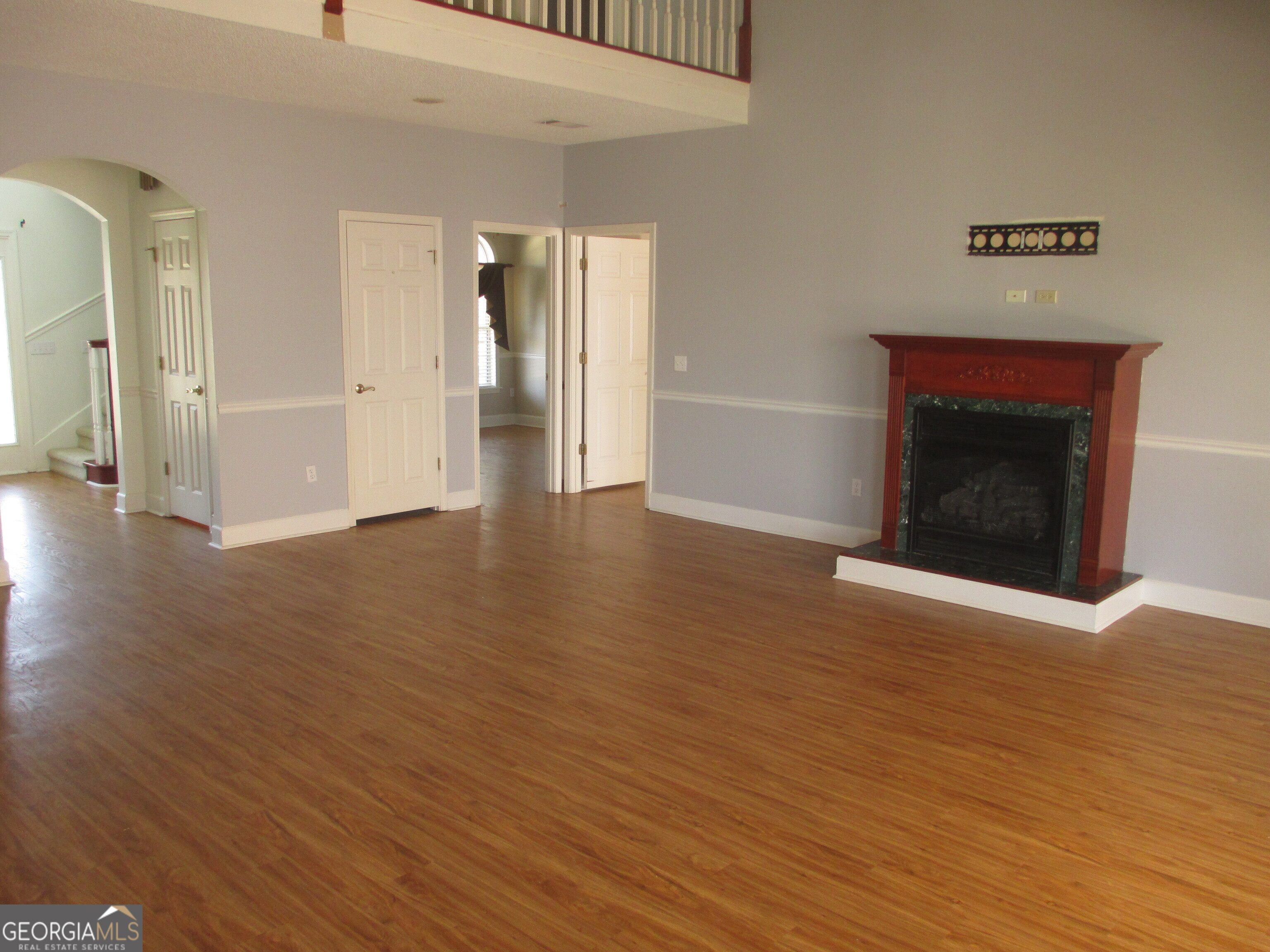 4262 Highway 15 Vidalia, GA 30474 - Photo 62 of 79 a view of an empty room with wooden floor and a fireplace
