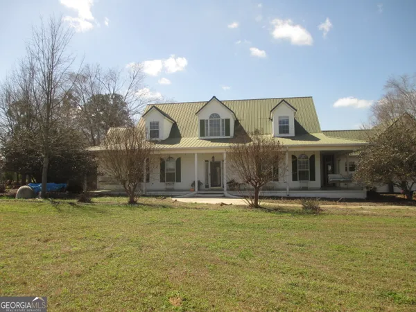 a view of a house with a yard and garage