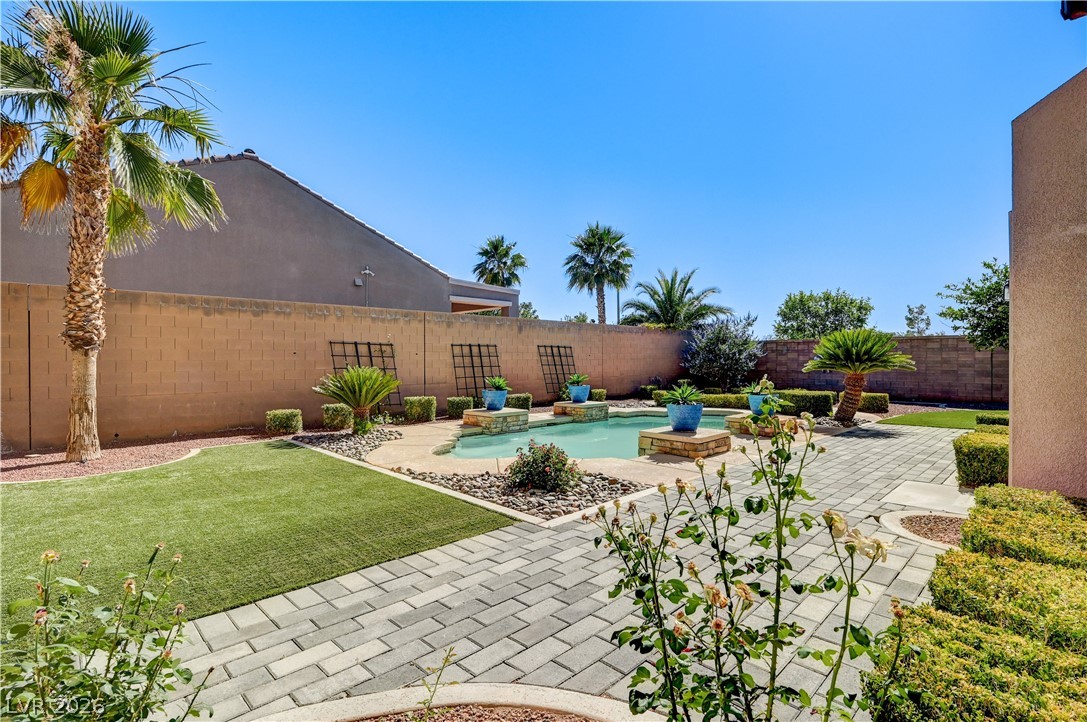2793 Rosenhearty Drive Henderson, NV 89044 - Photo 66 of 85 This private backyard oasis features a pool with ample paved and artificial turf patio space.