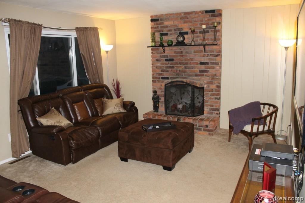 5221 North Fowlerville Road Fowlerville, MI 48836 - Photo 2 of 13 Living room with large windows that let the sunshine in.