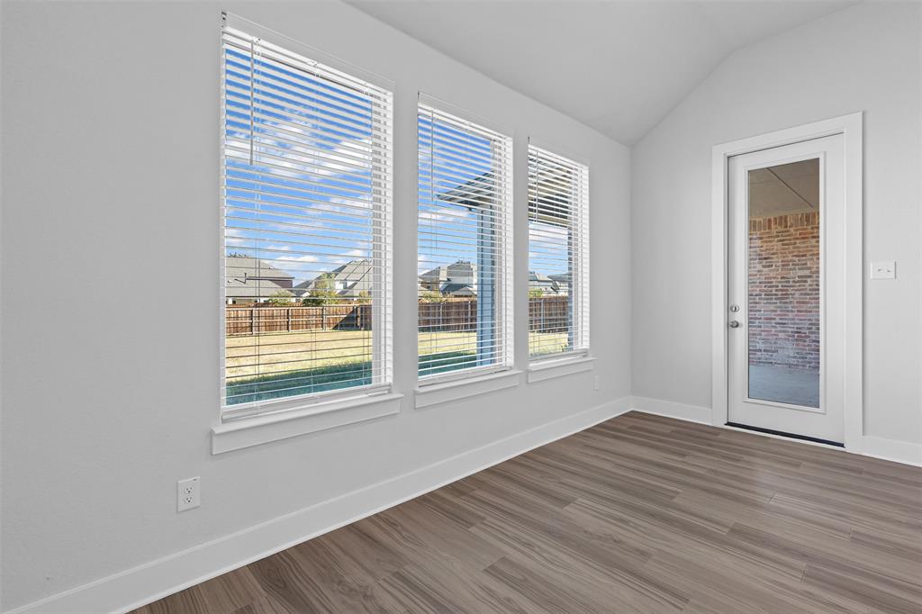 1770 English Way Waxahachie, TX 75165 - Photo 22 of 28 a view of an empty room with wooden floor and a window