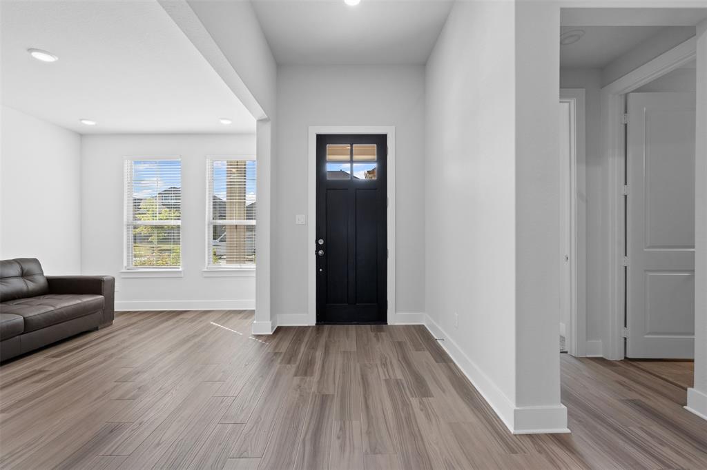 1770 English Way Waxahachie, TX 75165 - Photo 5 of 28 wooden floor in an empty room with a window