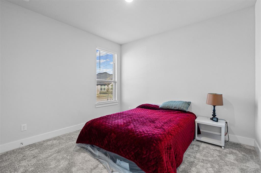 1770 English Way Waxahachie, TX 75165 - Photo 9 of 28 a bedroom with a bed and a table