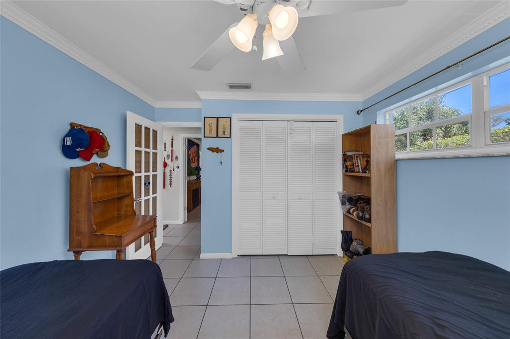 3213 Dover Road Pompano Beach, FL 33062 - Photo 20 of 53 a bedroom with a bed and cabinets