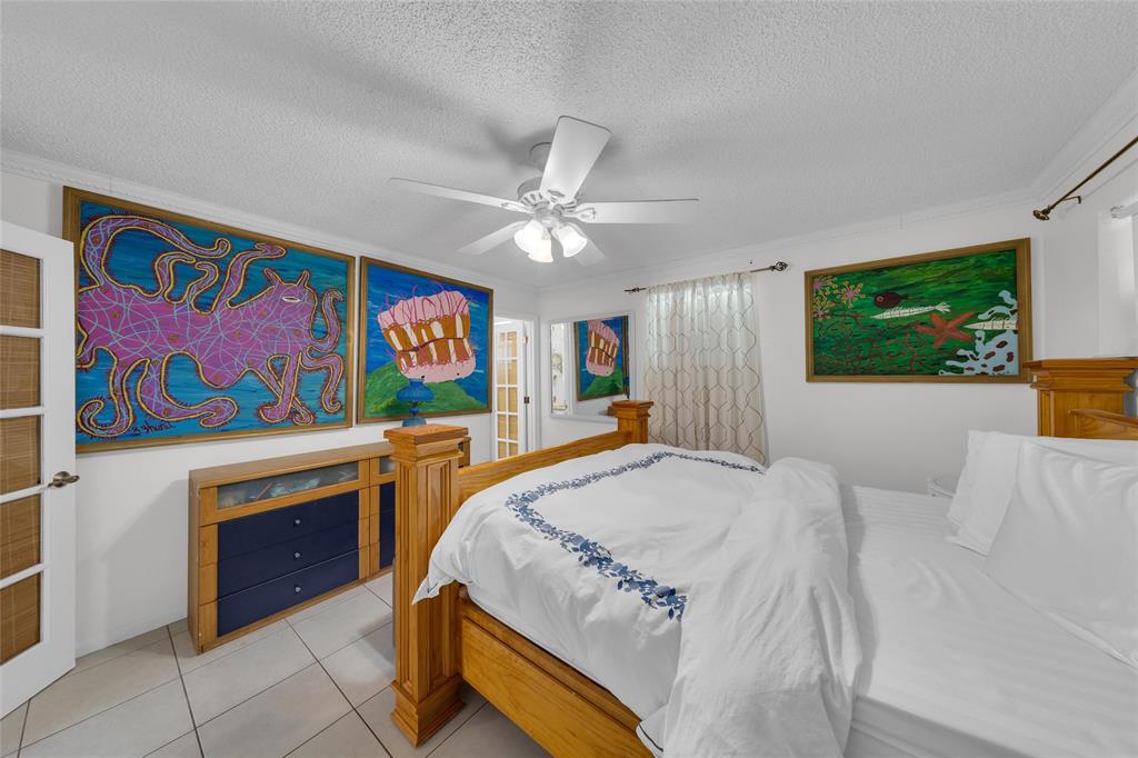 3213 Dover Road Pompano Beach, FL 33062 - Photo 22 of 53 a spacious bedroom with a bed and a painting on the wall