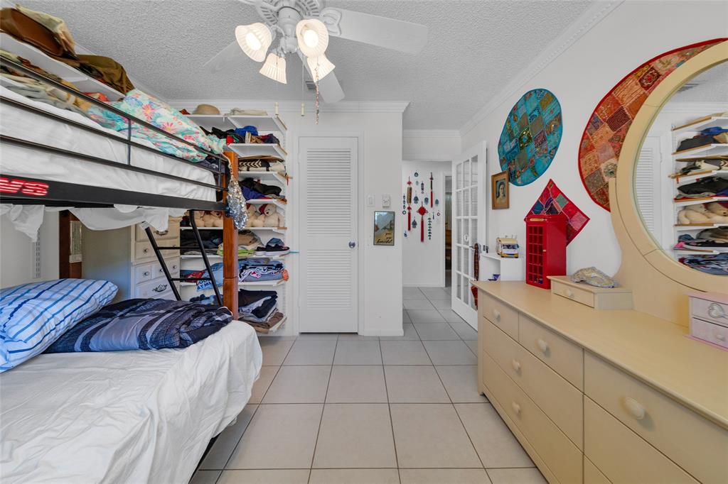 3213 Dover Road Pompano Beach, FL 33062 - Photo 27 of 53 a bedroom with a bed and a mirror on the dresser
