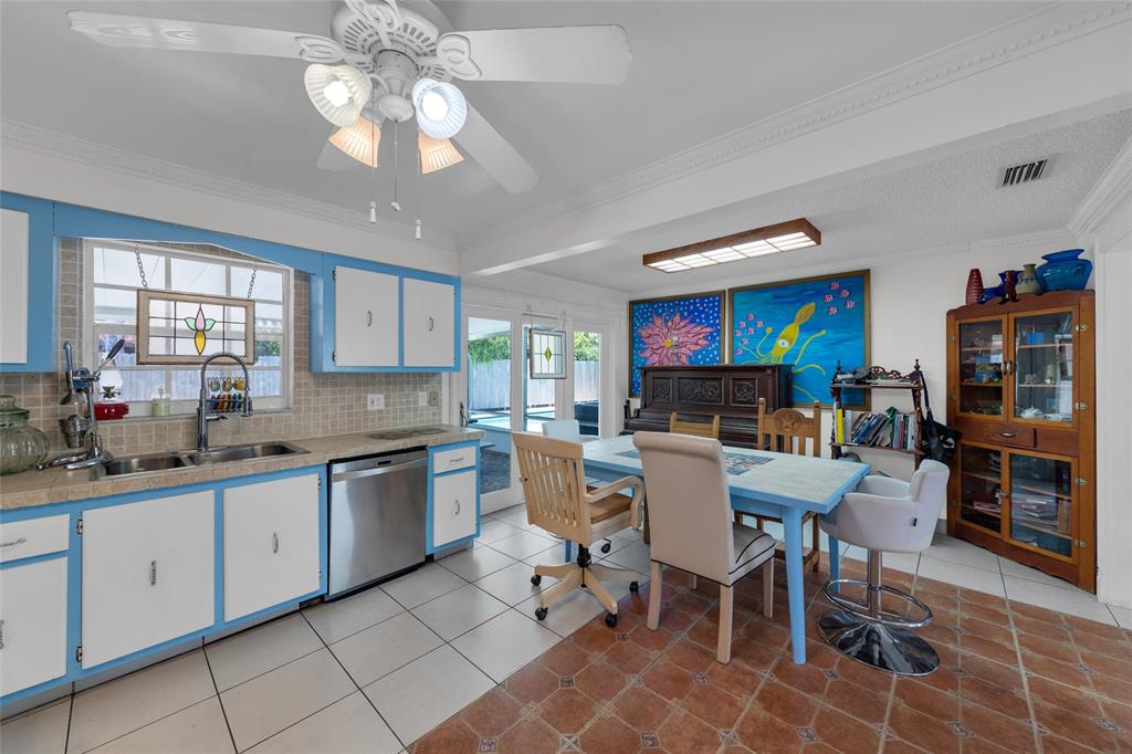 3213 Dover Road Pompano Beach, FL 33062 - Photo 36 of 53 a kitchen with stainless steel appliances a dining table and chairs