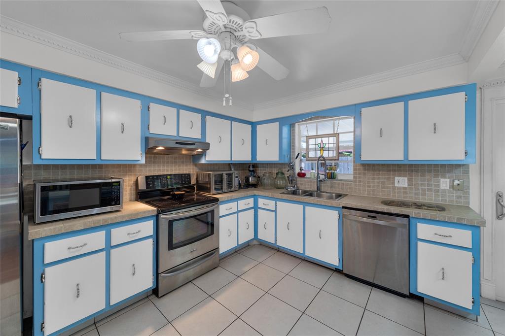 3213 Dover Road Pompano Beach, FL 33062 - Photo 38 of 53 a kitchen with granite countertop white cabinets white stainless steel appliances with a sink and dishwasher