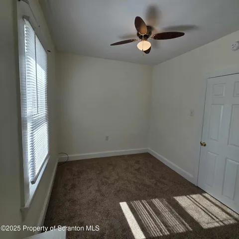 a very nice looking room with a ceiling fan