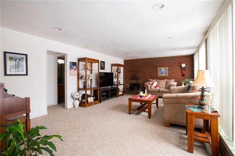 1117 Harvard Road Monroeville, PA 15146 - Photo 3 of 25 The living room, with an abundance of natural light, is perfect for welcoming family and friends into your home. The brick wall adds to the charm!