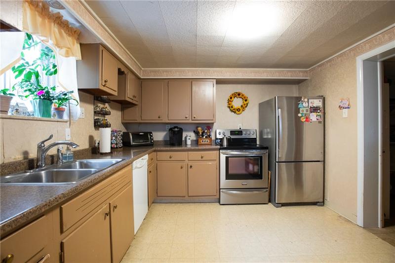 1117 Harvard Road Monroeville, PA 15146 - Photo 9 of 25 The kitchen offers neutral dcor, convenient entry to the dining room and family room, and natural lighting.