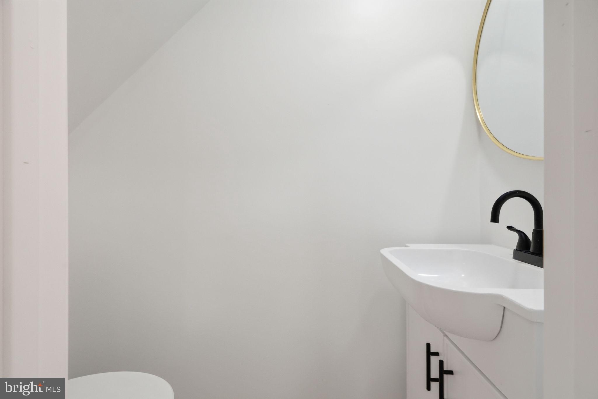 7413 Sommers Road Philadelphia, PA 19138 - Photo 15 of 54 a bathroom with a sink a toilet and mirror