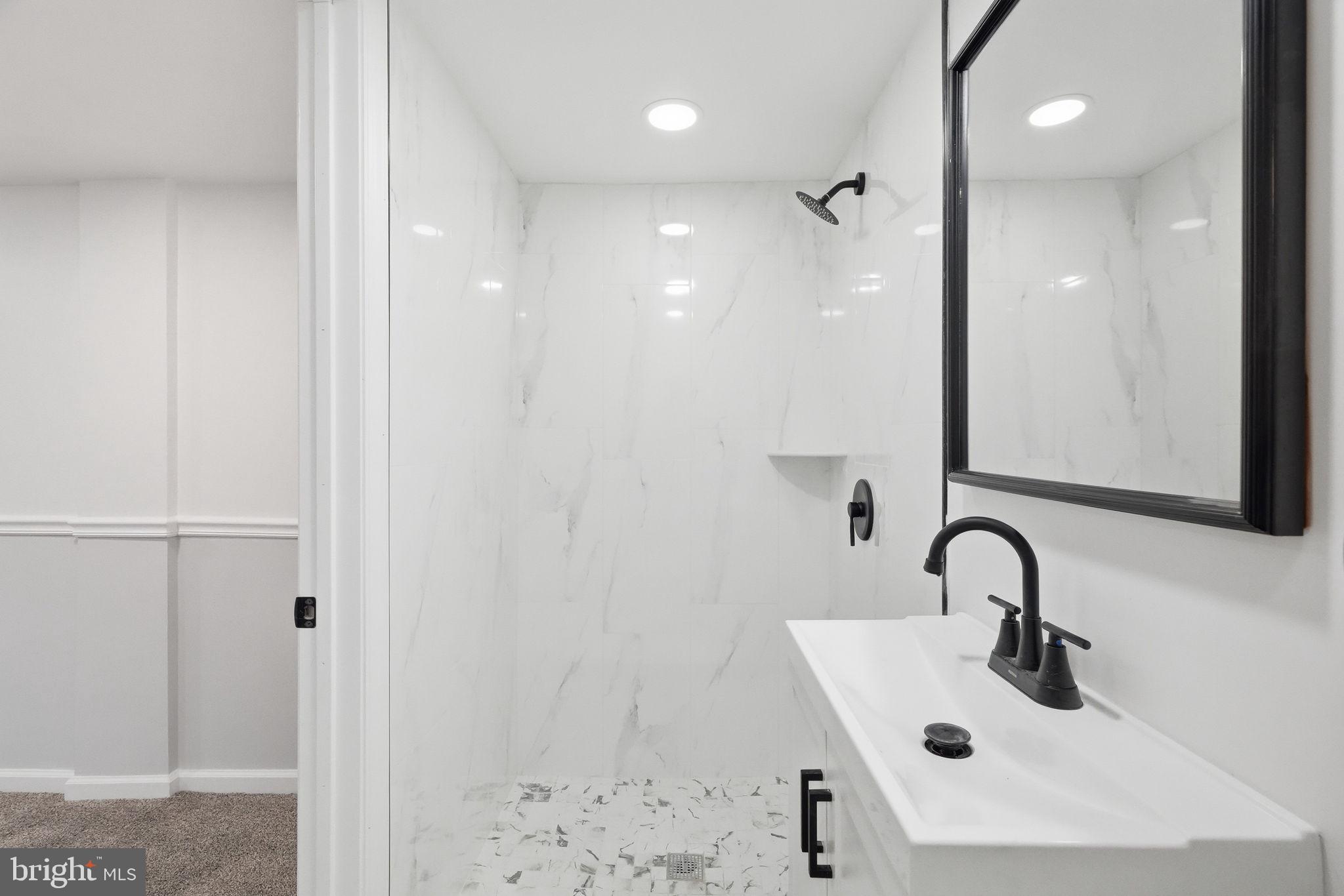7413 Sommers Road Philadelphia, PA 19138 - Photo 30 of 54 a bathroom with a sink and mirror