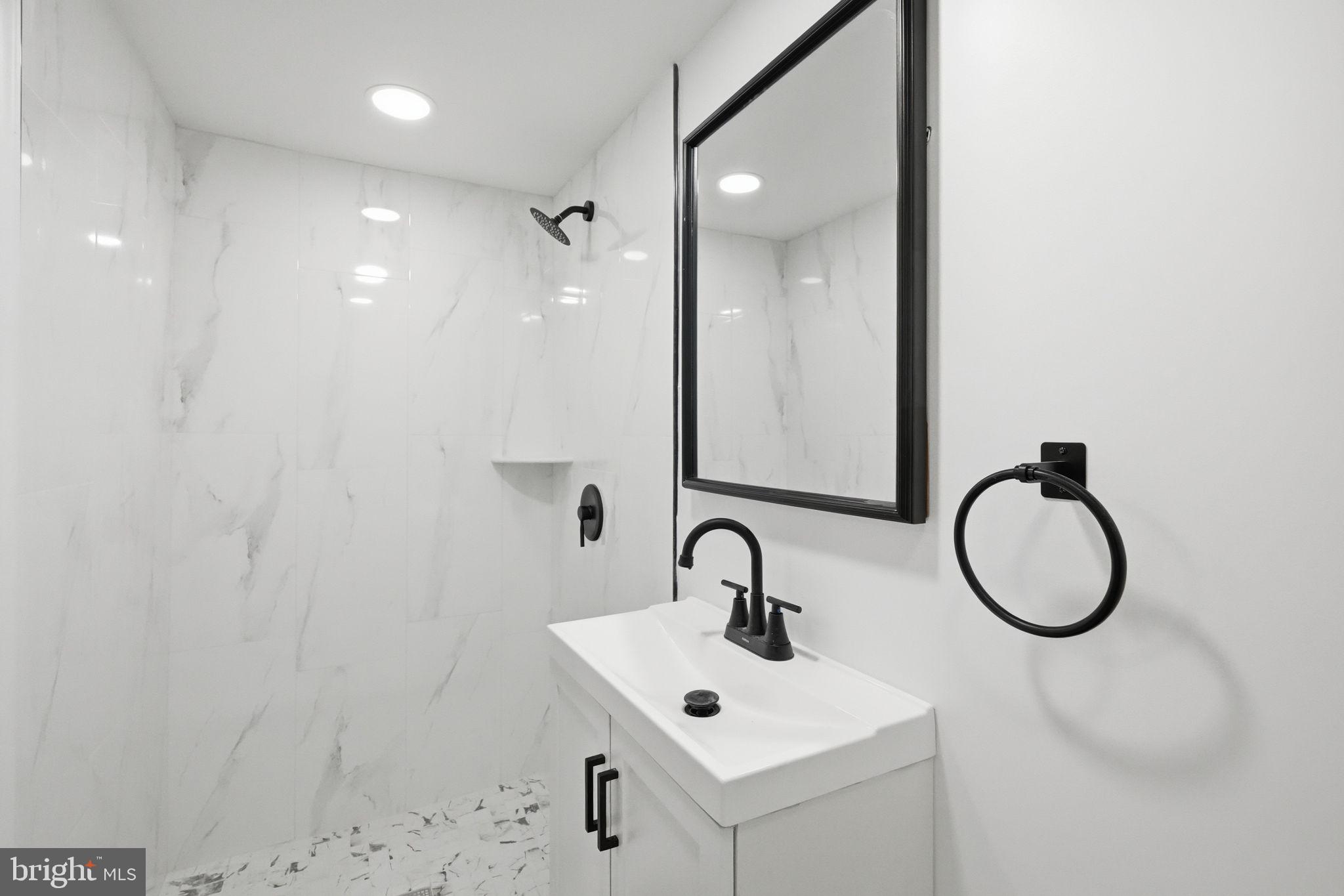 7413 Sommers Road Philadelphia, PA 19138 - Photo 33 of 54 a bathroom with a sink and mirror