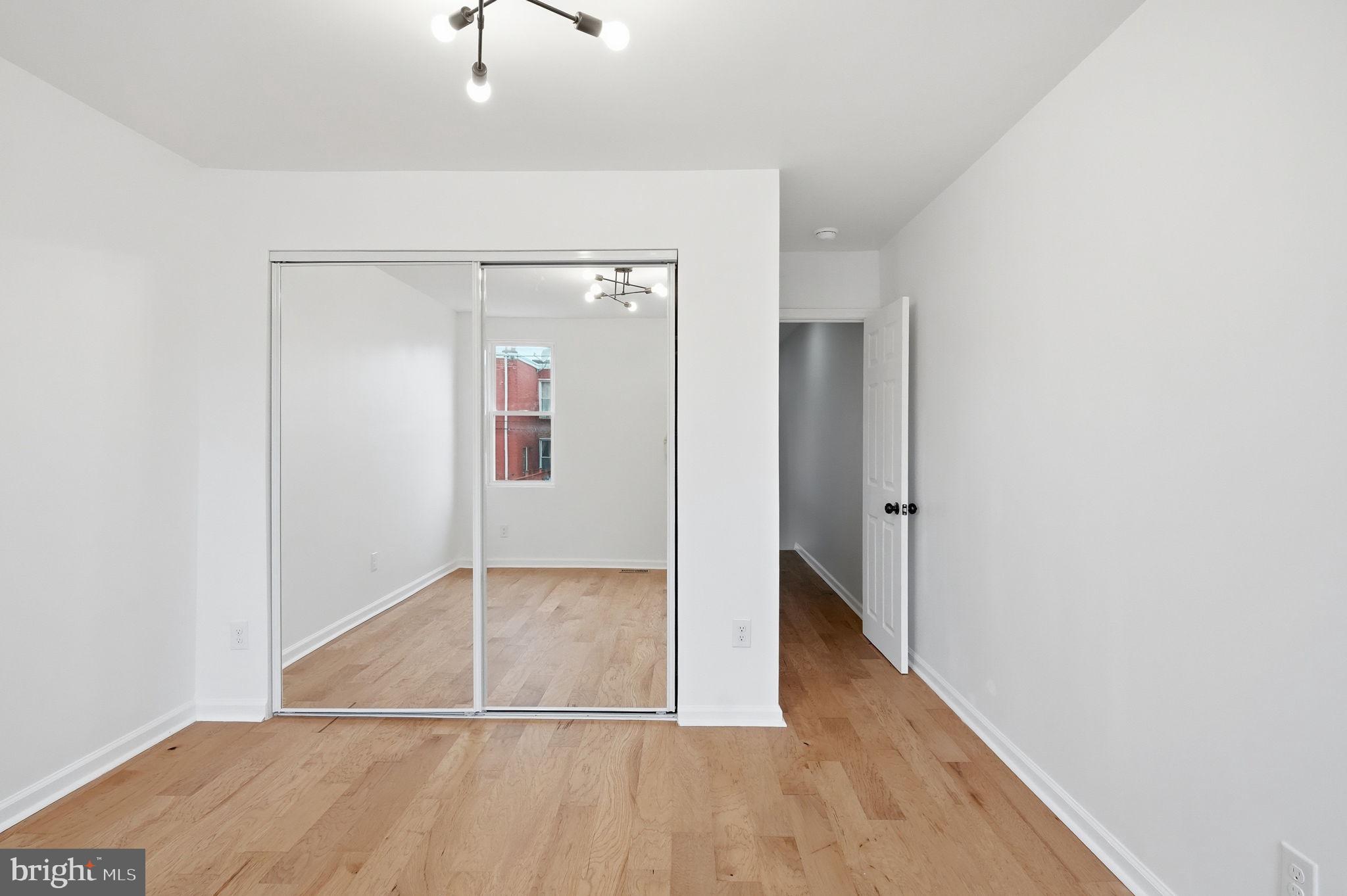 7413 Sommers Road Philadelphia, PA 19138 - Photo 37 of 54 an empty room with wooden floor and cabinet
