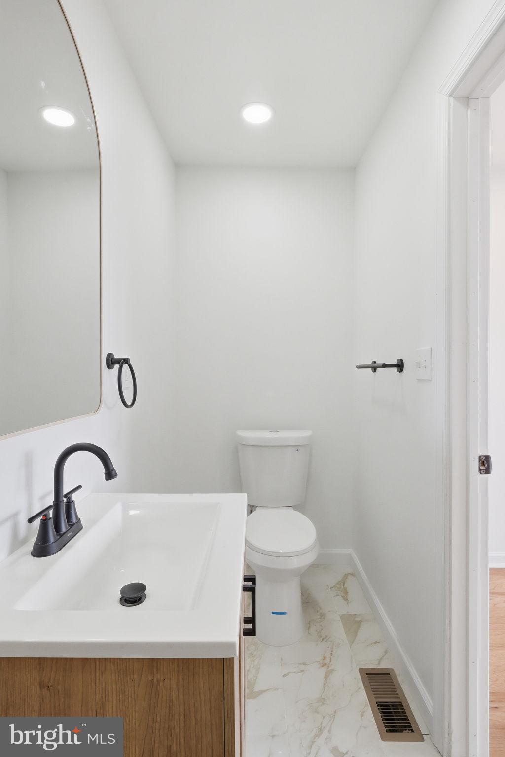 7413 Sommers Road Philadelphia, PA 19138 - Photo 49 of 54 a bathroom with a sink a toilet and a mirror