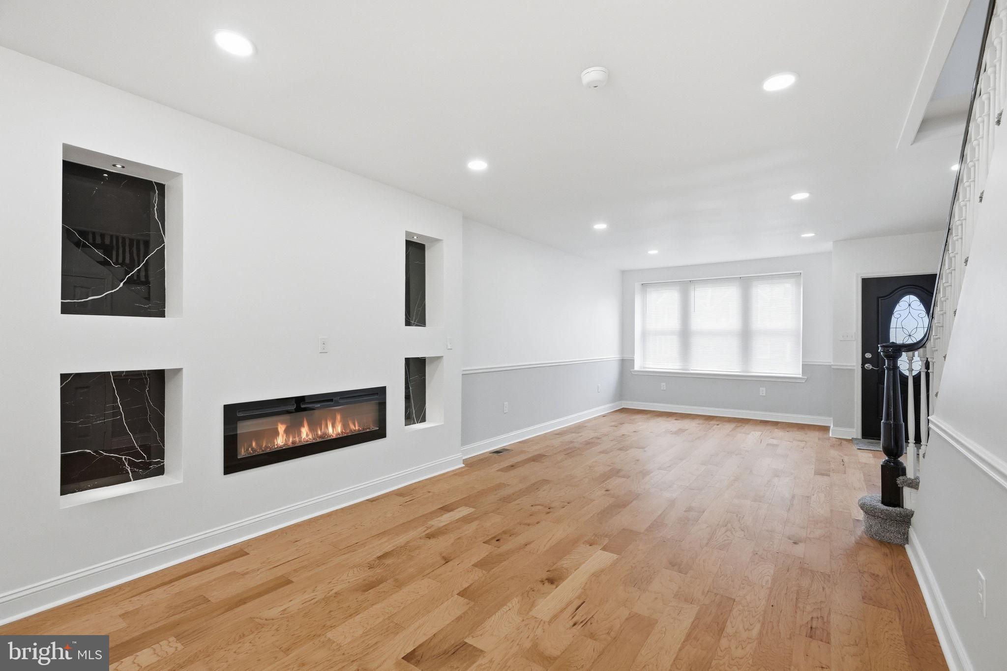 7413 Sommers Road Philadelphia, PA 19138 - Photo 9 of 54 a view of empty room with a fireplace and wooden floor