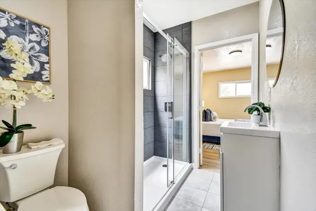 a large bed sitting in a bedroom next to a window