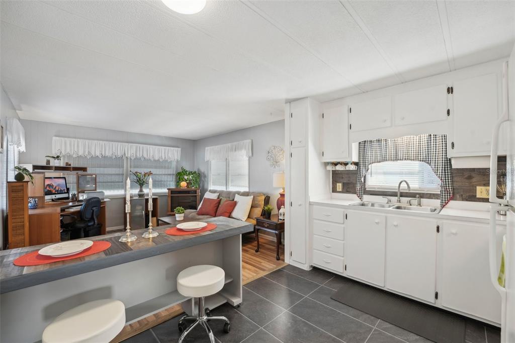 1600 Old Coachman Rd., Unit 709 Clearwater, FL 33765 - Photo 11 of 23 a kitchen that has a lot of cabinets a sink and it