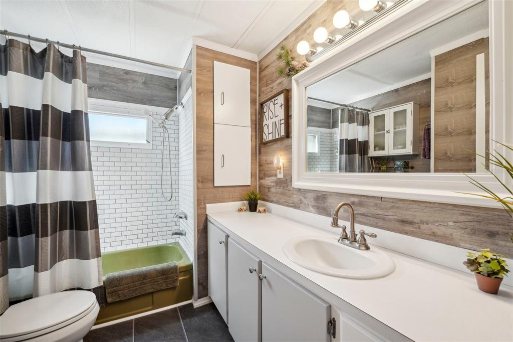 1600 Old Coachman Rd., Unit 709 Clearwater, FL 33765 - Photo 14 of 23 a bathroom with a sink double vanity and tub