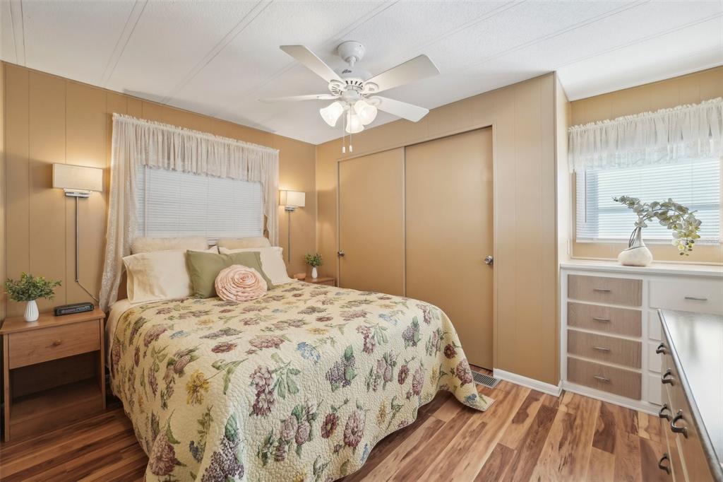 1600 Old Coachman Rd., Unit 709 Clearwater, FL 33765 - Photo 16 of 23 a bedroom with a bed and a chandelier