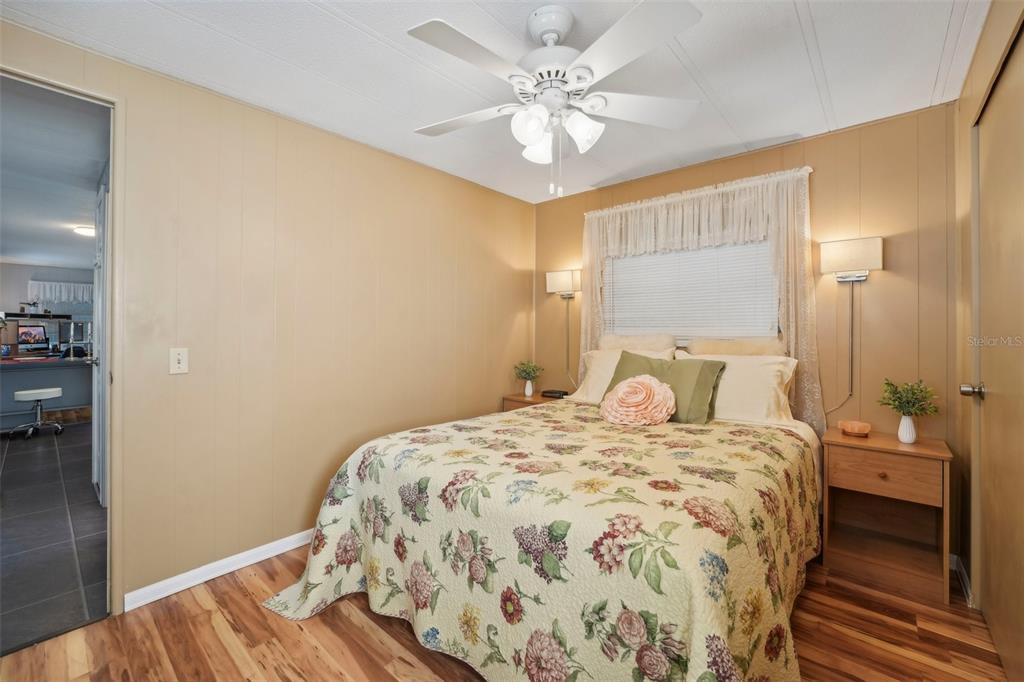 1600 Old Coachman Rd., Unit 709 Clearwater, FL 33765 - Photo 17 of 23 a bedroom with a bed and a chandelier