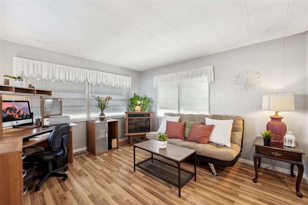 1600 Old Coachman Rd., Unit 709 Clearwater, FL 33765 - Photo 3 of 23 a living room with furniture and a table