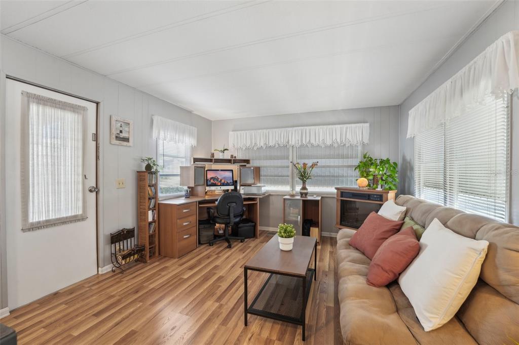 1600 Old Coachman Rd., Unit 709 Clearwater, FL 33765 - Photo 4 of 23 a living room with furniture kitchen view and a window